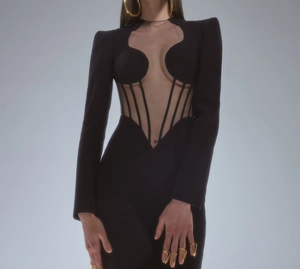 Detail of structured shoulders and sheer mesh panels on black evening party dress
