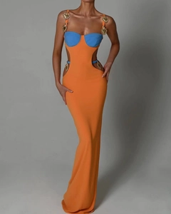 Detail of waist cut-outs and gold heart hardware on orange and blue bandage dress