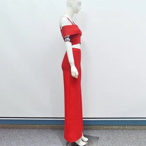 Detail view of red one-shoulder crop top and high-waisted wide-leg pants on mannequin