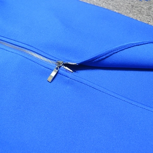 Detail of royal blue bandage dress fabric with a polished silver metal zipper