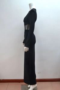 Detail of the sheer mesh cutout at the waist on this elegant long sleeve black evening dress