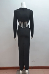 Detail of sheer mesh waist cut-outs and back slit on a black long-sleeve evening gown