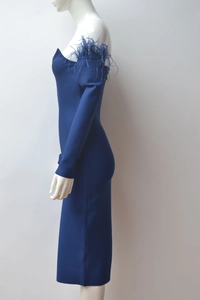 Side view of royal blue off-shoulder bandage dress with feather trim on the sleeve
