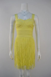 Detail of bright yellow bandage dress featuring slimming fit and long fringe tassel hem