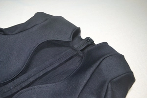 Detail view of the high-quality black bandage fabric texture and concealed zipper closure