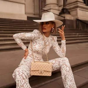 Elegant white lace long sleeve jumpsuit with floral embroidery and flared pants