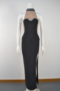 Detail of black halter evening dress with mesh patchwork and shimmering rhinestone trim