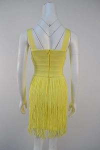 Detail view of yellow bandage dress back with fringe hem and concealed zipper closure