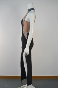 Detail view of black bandage dress featuring sheer mesh panels and sparkling rhinestones