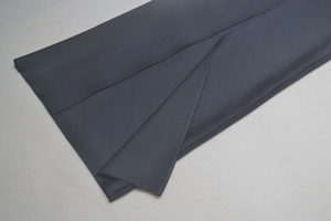 Detailed close-up of the high-slit hem on a black bodycon mesh party evening dress