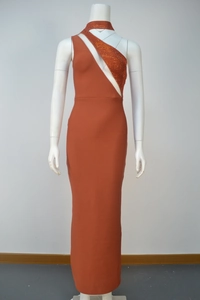 Detail of caramel bandage dress featuring rhinestone shoulder strap and waist cutout
