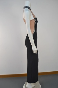 Detail view of the silver rhinestone trim and mesh panel on the black bandage dress