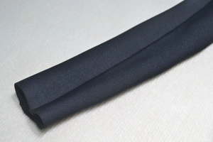 Close-up of the black sheer mesh sleeve texture and fine elastic ribbed fabric detail