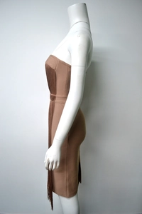 Detail view of brown bandage dress showing long fringe accents on high-quality fabric