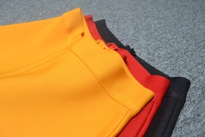 Detail of high-density bandage fabric and matching metal zipper on high-waist trousers