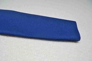 Macro detail of royal blue bandage dress fabric showing premium knit texture