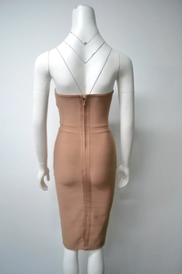 Detailed back view of a camel bandage dress showing the vertical zipper and ribbed fabric