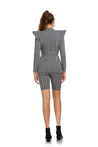 Rear view of women's two-piece suit showing black and white jacquard maze pattern details
