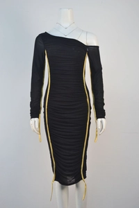 Detail of ruched black dress with asymmetrical neckline and gold zipper trims