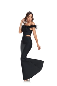 Detail of off-shoulder top with black ostrich feathers and high-waist mermaid skirt set