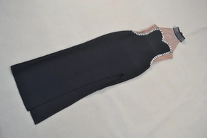 Detail of the elegant black evening dress showing sheer mesh panel and sparkling rhinestones
