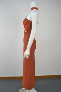 Detail of orange rhinestones on a sleeveless cutout bandage dress with mesh finish