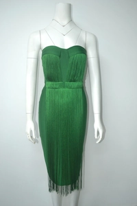 Detail of emerald green bandage dress featuring long tiered fringe and strapless neckline