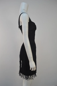 Detail of black mini bandage dress featuring side hidden zipper and layered fringe hemline