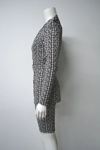 Detail of black and white labyrinth jacquard fabric texture on a cinched waist blazer