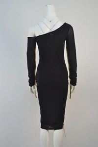 Detail of elegant black one-shoulder party dress with golden decorative streamers on sleeve