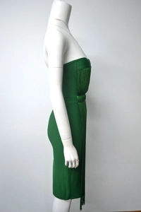 Detail showing emerald green fringe and high-stretch bandage fabric on dress
