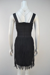 Detailed back view of a black bandage dress featuring long tassels and a zipper closure
