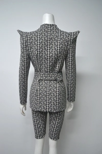 Rear view of women's two-piece suit featuring black and white geometric maze jacquard texture