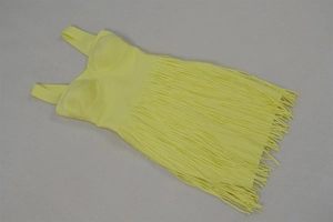 Detail of vibrant yellow bandage dress featuring thick straps and dense tiered fringe hem