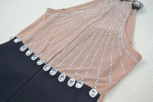 Detail of mesh bodice with sparkling rhinestones and large crystal accents on the waistline