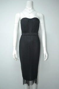 Detailed close-up of a black strapless bandage dress with long swaying fringe details