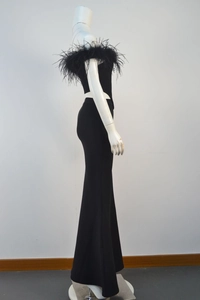 Detailed close-up of the elegant black ostrich feather trim on the off-shoulder evening dress