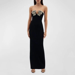 Detail of black strapless evening gown featuring silver snake-shaped rhinestone embellishments