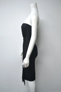 Detail view of black bandage dress with fringe hem and bodycon sleeveless design