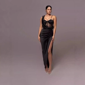 Detail of black satin evening gown featuring boned corset bodice and high slit hemline