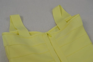 Detail of back hidden zipper and wide straps on yellow bandage mini dress