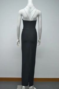 Detail view of the backless deep V-neck and crisscross straps on this black formal dress
