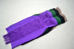 Detailed view of strapless bandage dresses with elegant long fringe in multiple colors