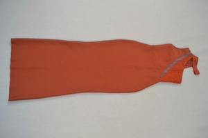 Detail of orange bodycon dress featuring crystal-studded mesh neckline and sequins
