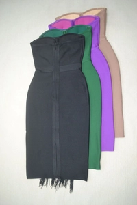 Flat lay of sleeveless bandage dresses with fringe hems in black, green, purple and pink