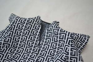 Macro detail of the jacquard fabric showing a black and white geometric labyrinth pattern