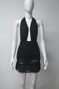 Detailed view of black halter neck dress with deep V-neck and ruched fabric design