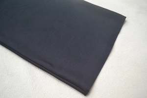 Detailed close-up of premium black bandage fabric with high-quality flat stitching