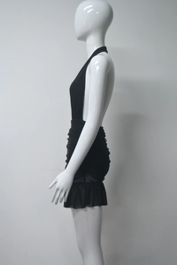 Detail of the black halter dress featuring side ruching and semi-transparent mesh hemline