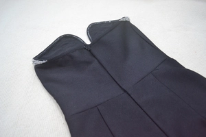 Detail of black sweetheart neckline bandage dress with sparkling silver rhinestones and zipper